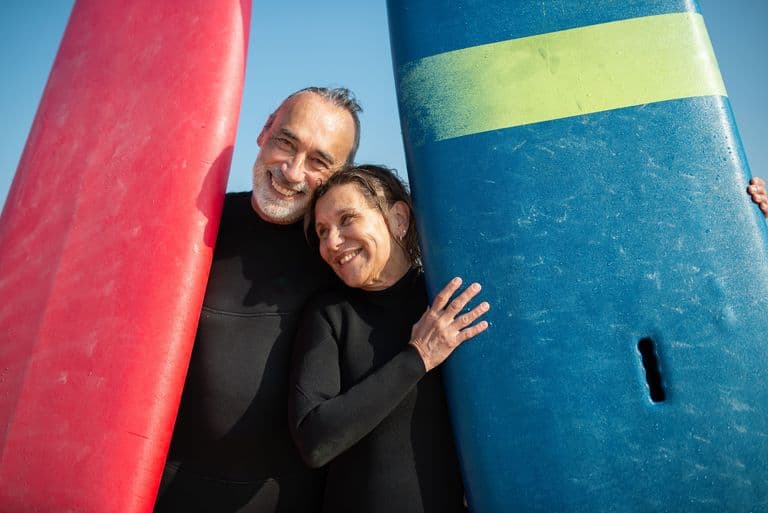 A retired couple surfing